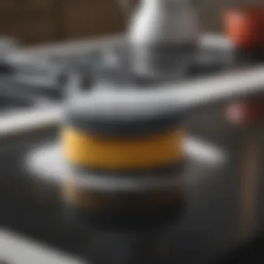 Gentle Yet Effective Cleaning Technique Close-up of a scrubber on a cooktop