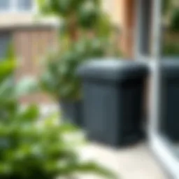 A compact compost bin on a balcony with greenery around.