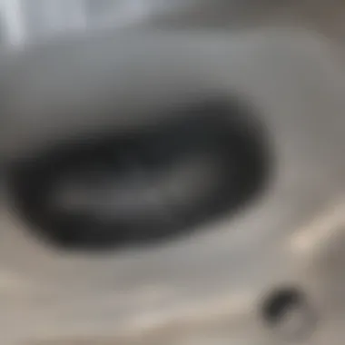 Close-up view of a clogged shower drain with hair and soap buildup
