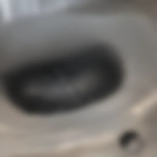 Close-up view of a clogged shower drain with hair and soap buildup