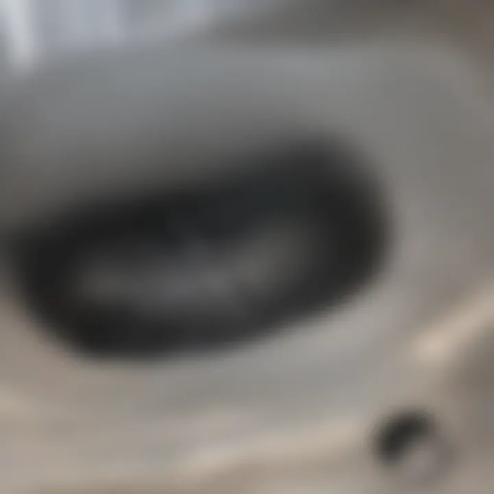 Close-up view of a clogged shower drain with hair and soap buildup